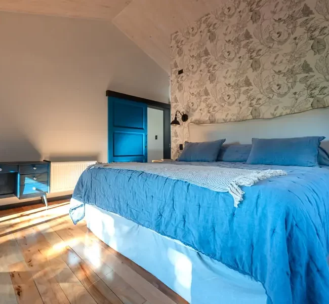 Dormitorio con techo abovedado, priorizando el diseño y el confort térmico con ventanas de alta eficiencia.